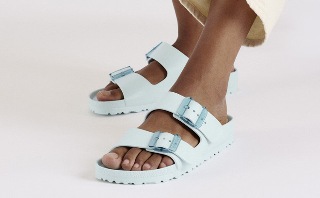 A Person Wearing Birkenstock Arizona Stealth Buckle EVA Womens Slide Sandals A Person Wearing Birkenstock Arizona Stealth Buckle EVA Womens Slide Sandals