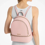 A Person Wearing Michael Kors Rhea Medium Pebbled Leather Backpack