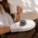 A Person Wearing Red Light Hand Massager
