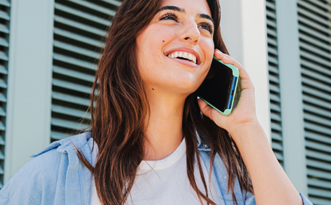 A Smiling Woman Talking on a Mobile Phone A Smiling Woman Talking on a Mobile Phone
