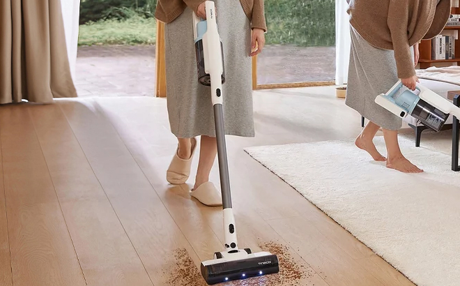 A Woman Cleaning with the Tineco GO Cordless 2 in 1 Stick Handheld Vacuum