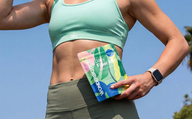 A Woman Holding Daily Fiber Mix Supplement Powder Packets A Woman Holding Daily Fiber Mix Supplement Powder Packets