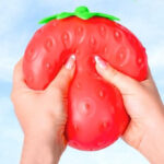 A Woman Holding Sunny Days Entertainment Strawberry Squishy