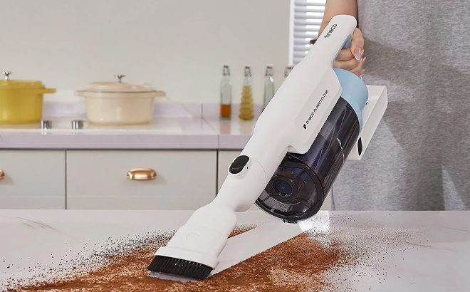 A Woman Using the Tineco GO Cordless 2 in 1 Stick Handheld Vacuum