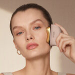 A Woman Using the ZDEER Electric Heated Gua Sha Red Light Face Massager