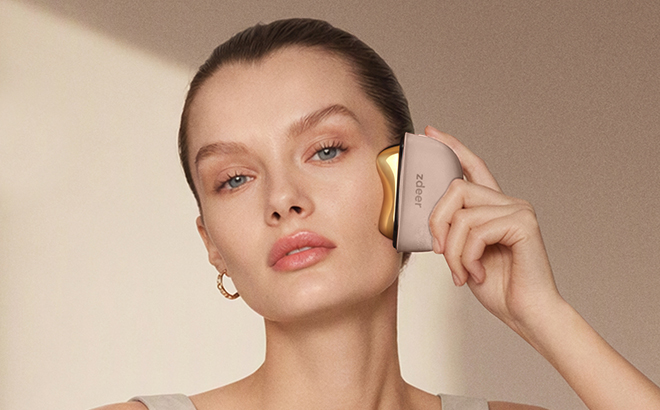 A Woman Using the ZDEER Electric Heated Gua Sha Red Light Face Massager