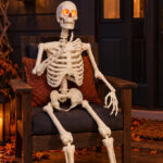 Haunted Living 5 ft Ultra Posable Skeleton Halloween Decoration on the Chair