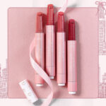 Tarte Love Notes Maracuja Juicy Lip Balm 4 Piece Lip Warderobe on Pink Background