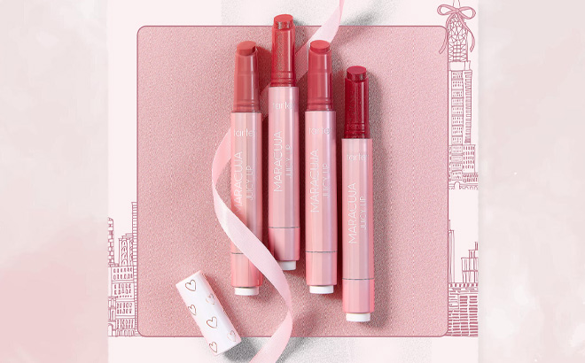 Tarte Love Notes Maracuja Juicy Lip Balm 4 Piece Lip Warderobe on Pink Background Tarte Love Notes Maracuja Juicy Lip Balm 4 Piece Lip Warderobe on Pink Background