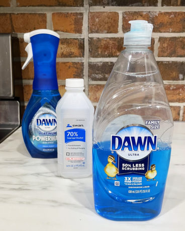 Dawn Powerwash Dish Spray Bottle with Isopropyl Alcohol Bottle and Dawn Dish Soap Bottle on a Countertop
