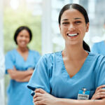 A Smiling Nurse with Coworkers in the Background