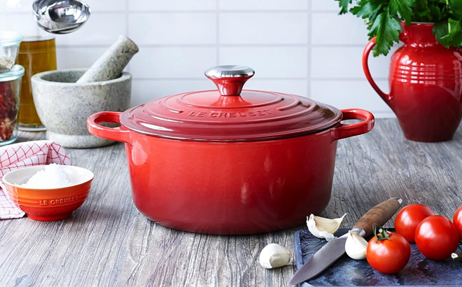 Red Le Creuset Cast Iron Dutch Oven on a Tabletop